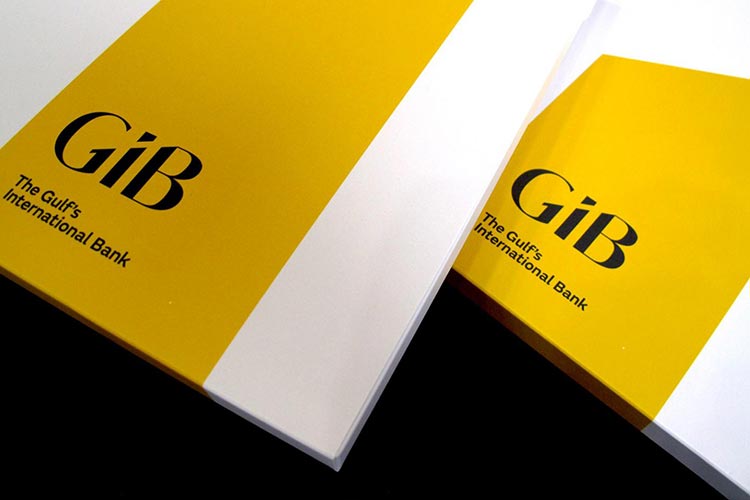 Two corporate book covers feature a striking diagonal split design of bright yellow and clean white, prominently displaying the bold black logo "GiB" alongside the text "The Gulf's International Bank."