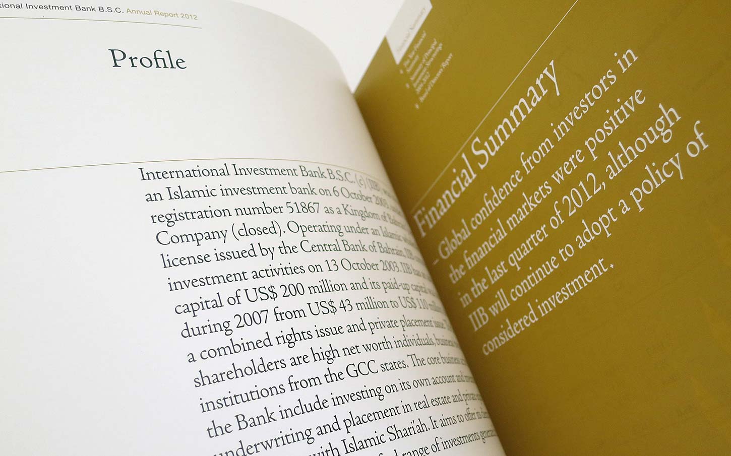 An open spread of the International Investment Bank B.S.C. 2012 Annual Report, showing a "Profile" page with descriptive text about the bank on the left and a gold-colored "Financial Summary" page on the right.