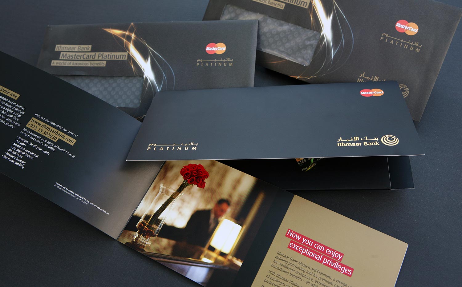 A collection of premium black envelopes and marketing materials for the Ithmaar Bank MasterCard Platinum credit card, featuring gold branding, the Mastercard logo, and imagery of a person in a sophisticated dining setting to highlight the card's "exceptional privileges."
