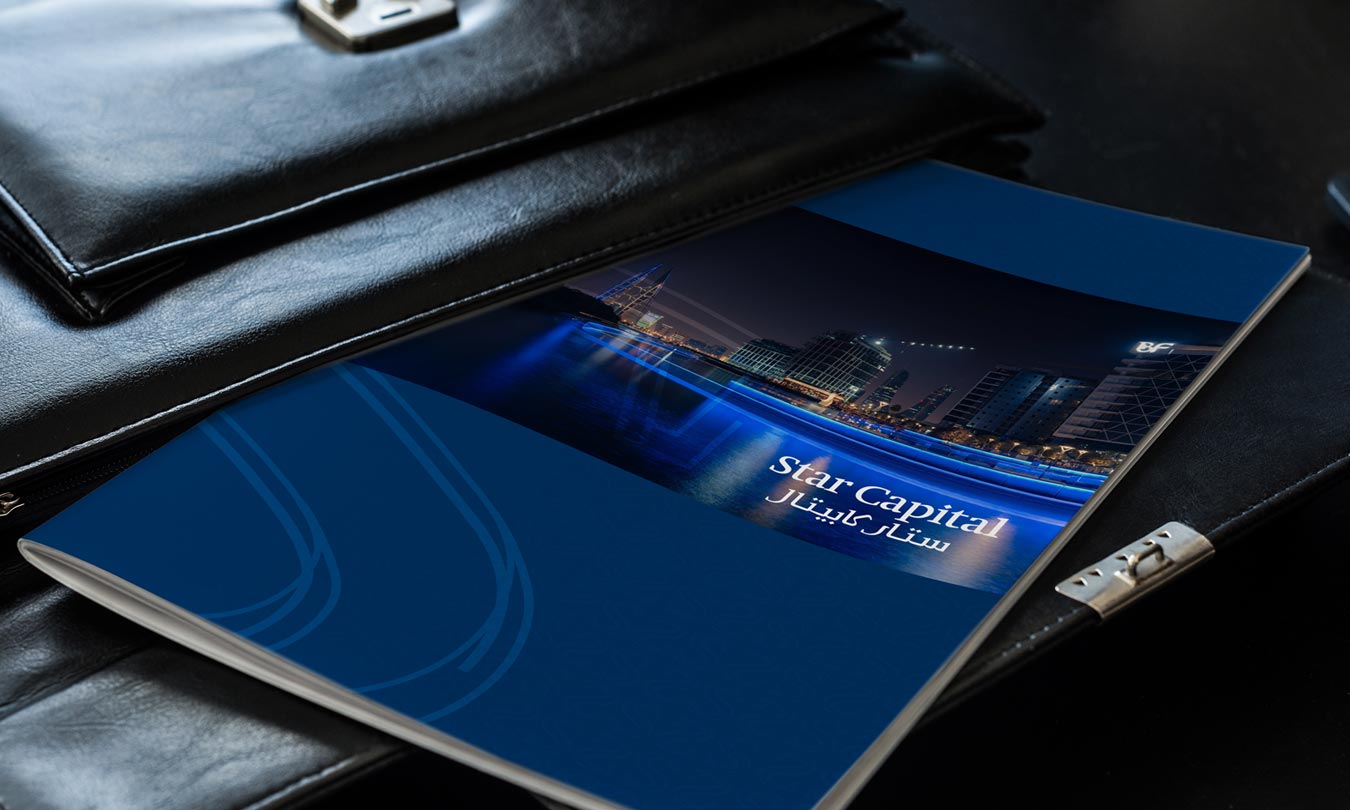 Printed investment portfolio brochure cover design for Star Capital featuring an evening cityscape image and bilingual branding.