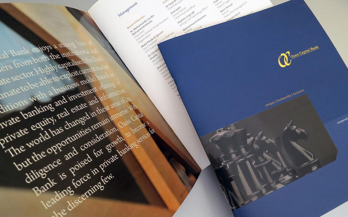 An open Oasis Capital Bank corporate brochure displaying an investment management text page next to a dark blue cover featuring a gold logo and a black-and-white chess piece graphic.